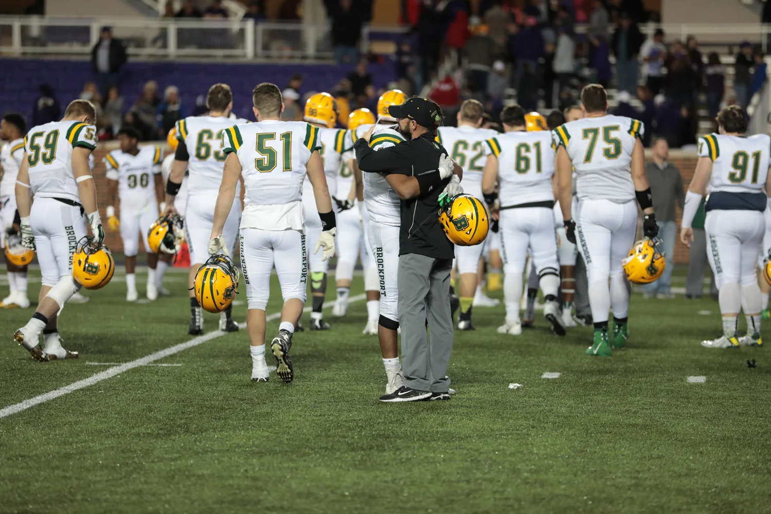 Brockport player hugging Coach Mangone