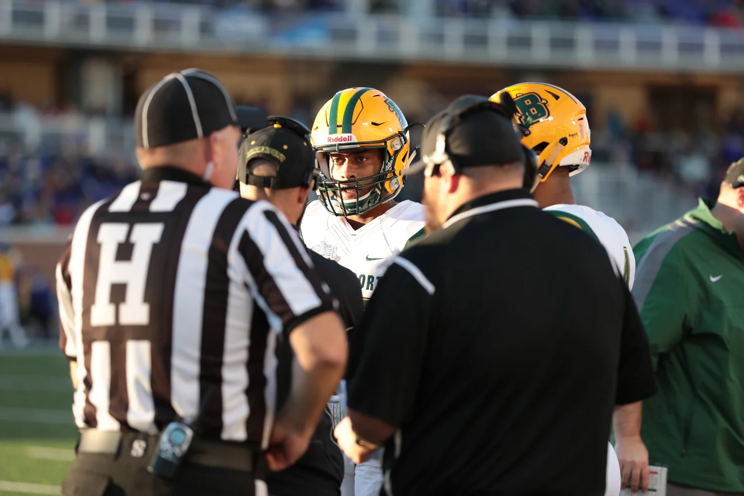 WR listening to coach during a timeout