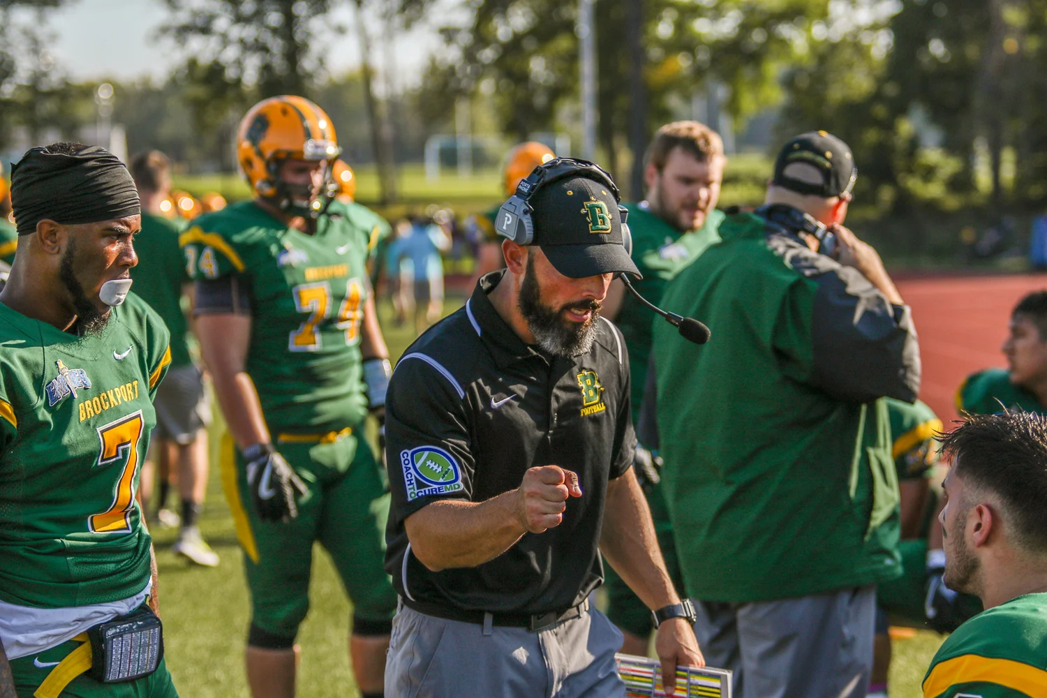 Coach Mangone talking to his team on the sidelines