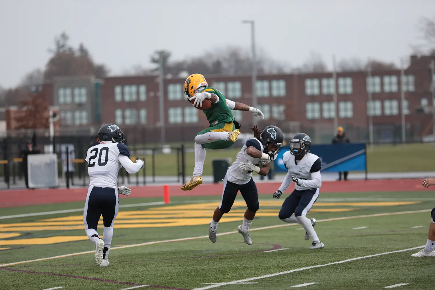 Brown jumping over the defender to reach the endzone