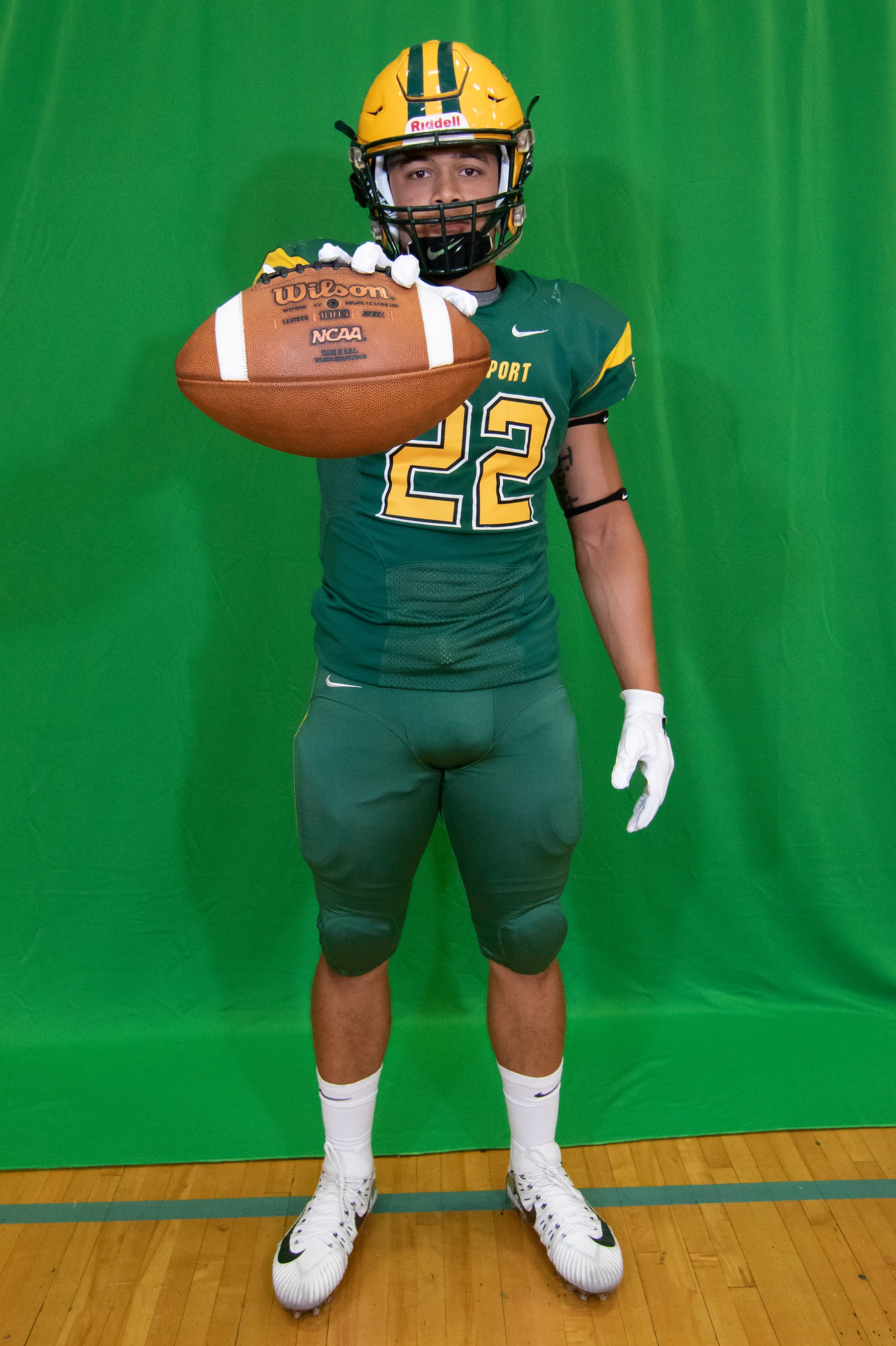 Running Back posing with the ball on Brockport Football Media Day