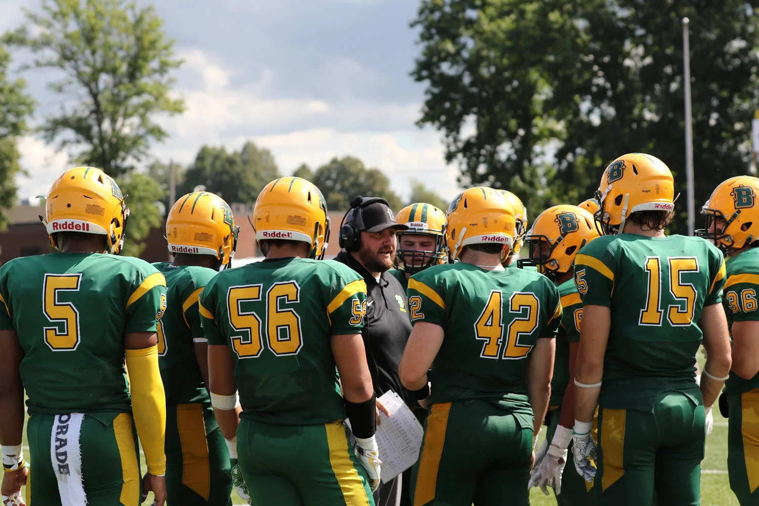 Coach talking to the team in the huddle