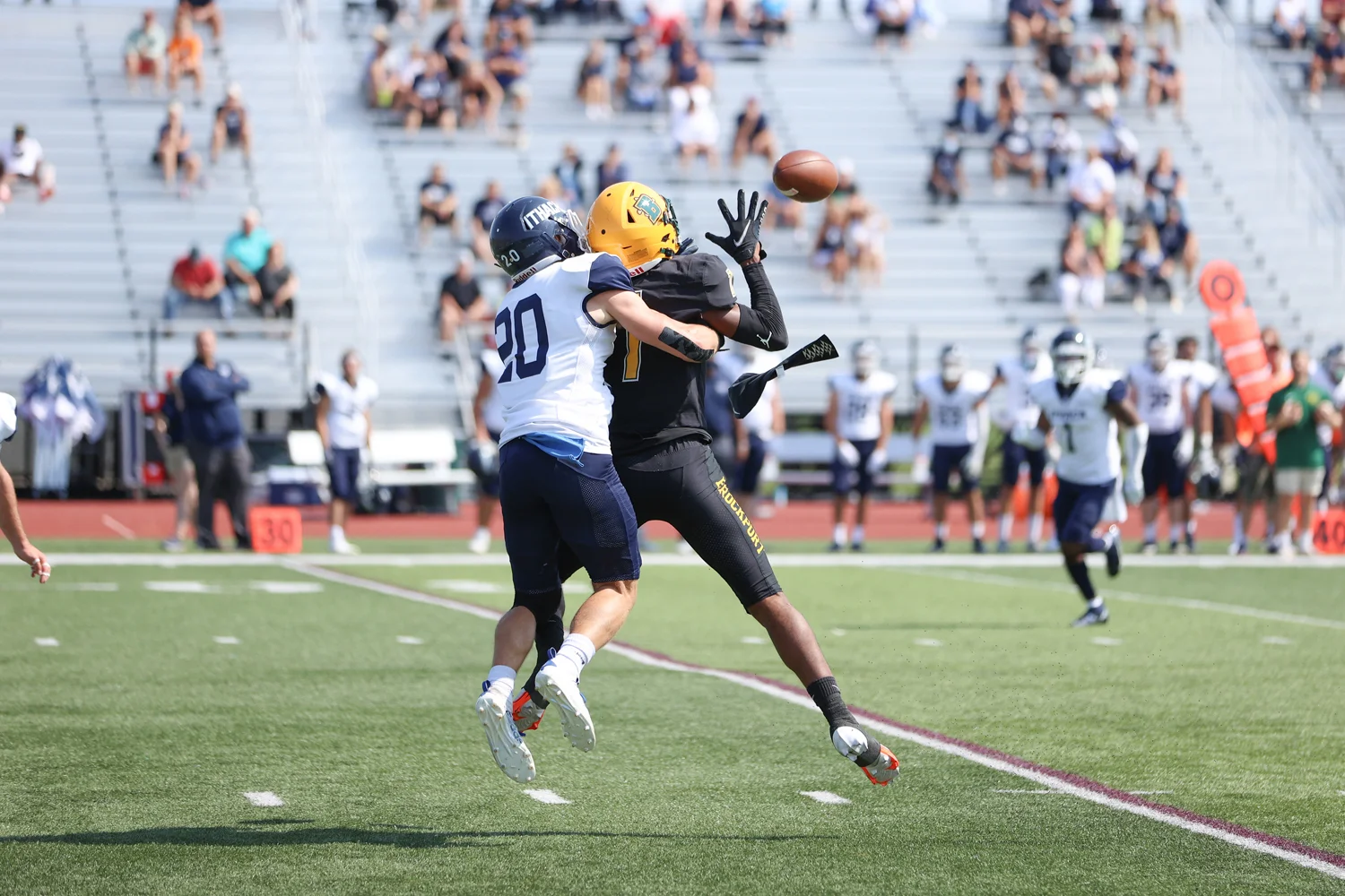 Brockport WR going up for a contested ball against the Ithaca DB
