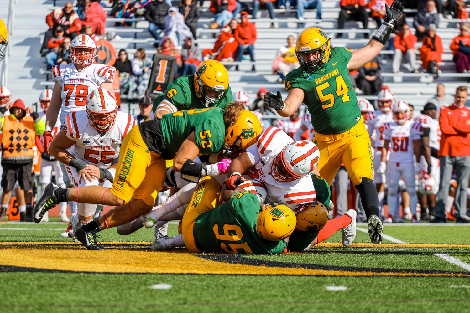 Defense making the tackle against Cortland