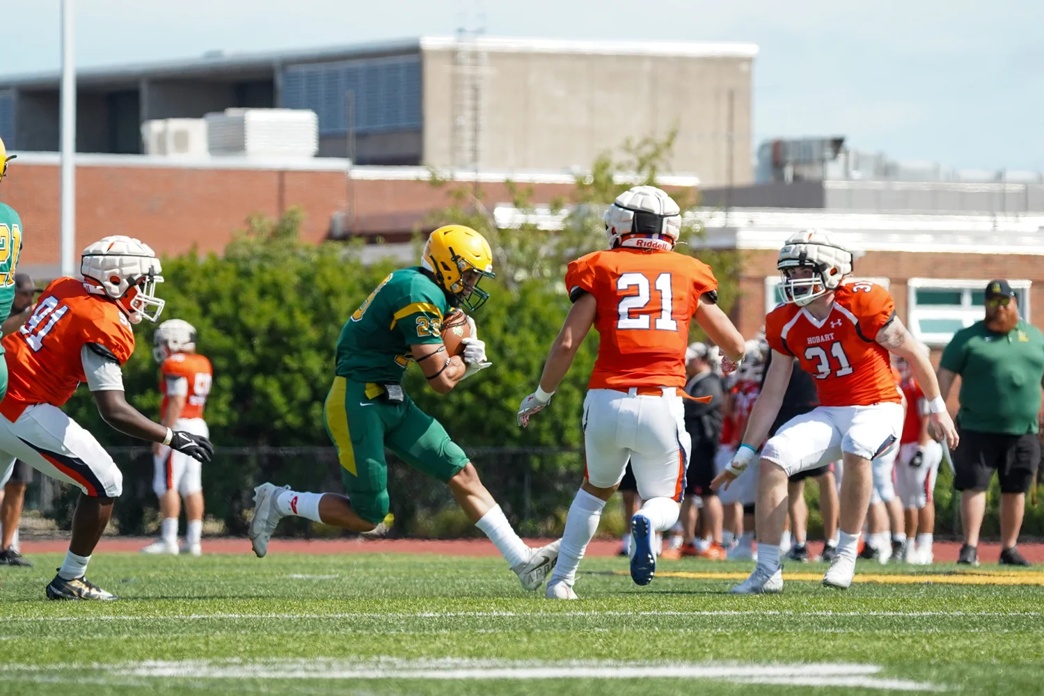 RB encounters defenders and holds the ball tight