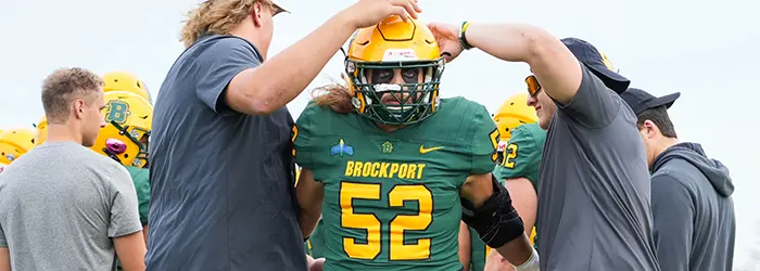 Brockport Senior running by his teammates