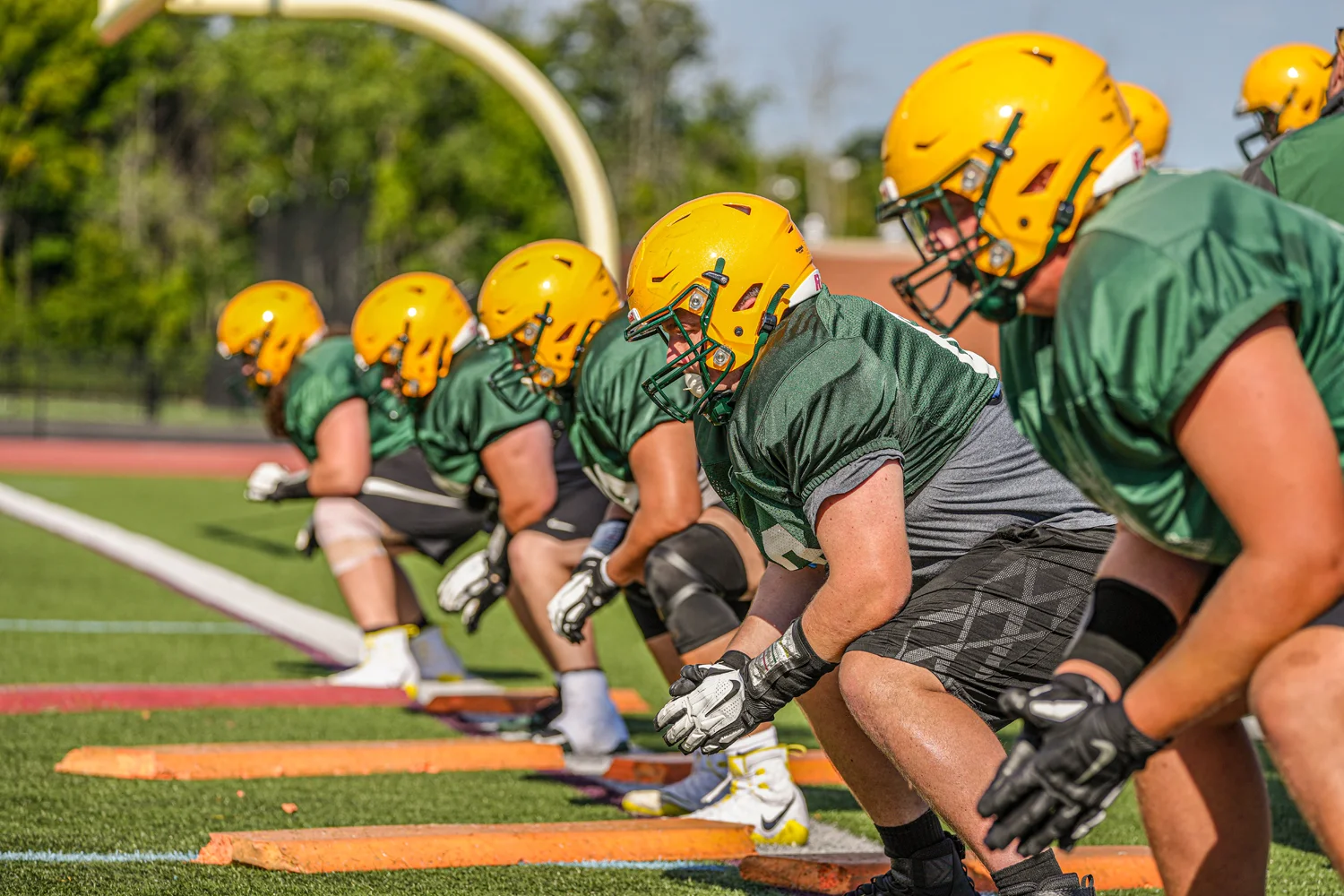 Offensive lineman in their stance during practice