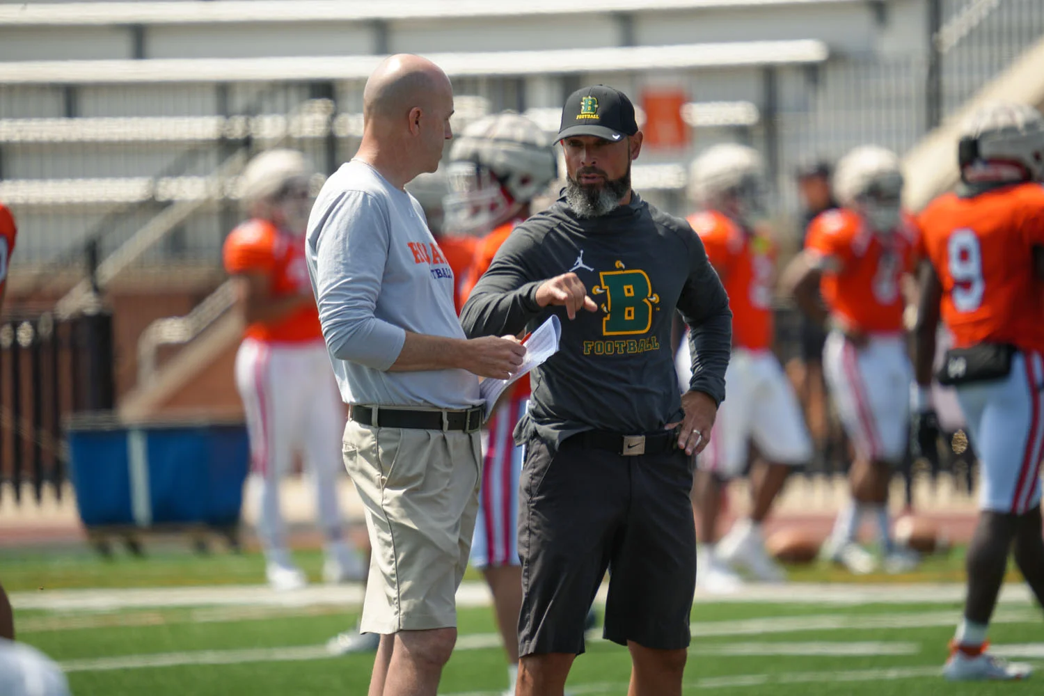 Head coaches talking before the scrimmage
