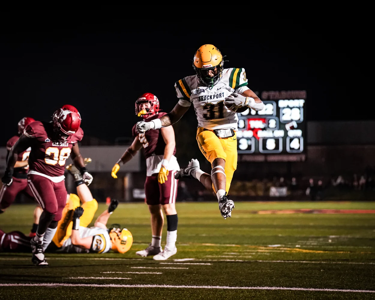 Brockport RB jumping over the goalline for the TD