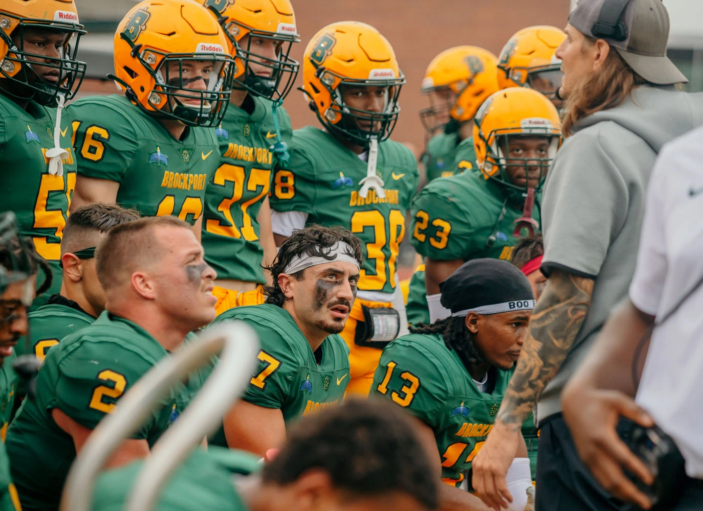 The Brockport Defense listening to coach along the sidelines