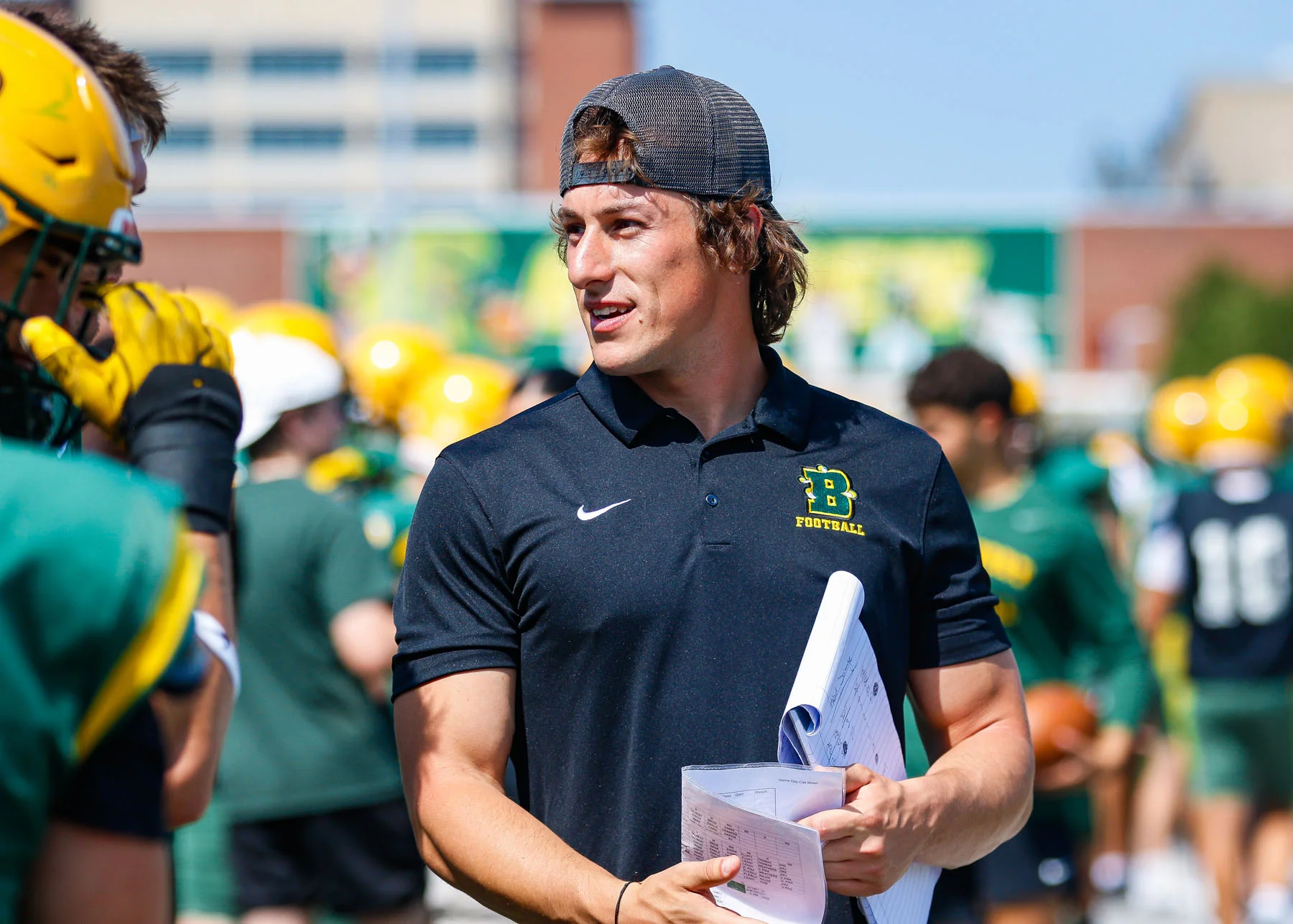 Brockport Coach Jake O'Connell talking to the players on the sidelines