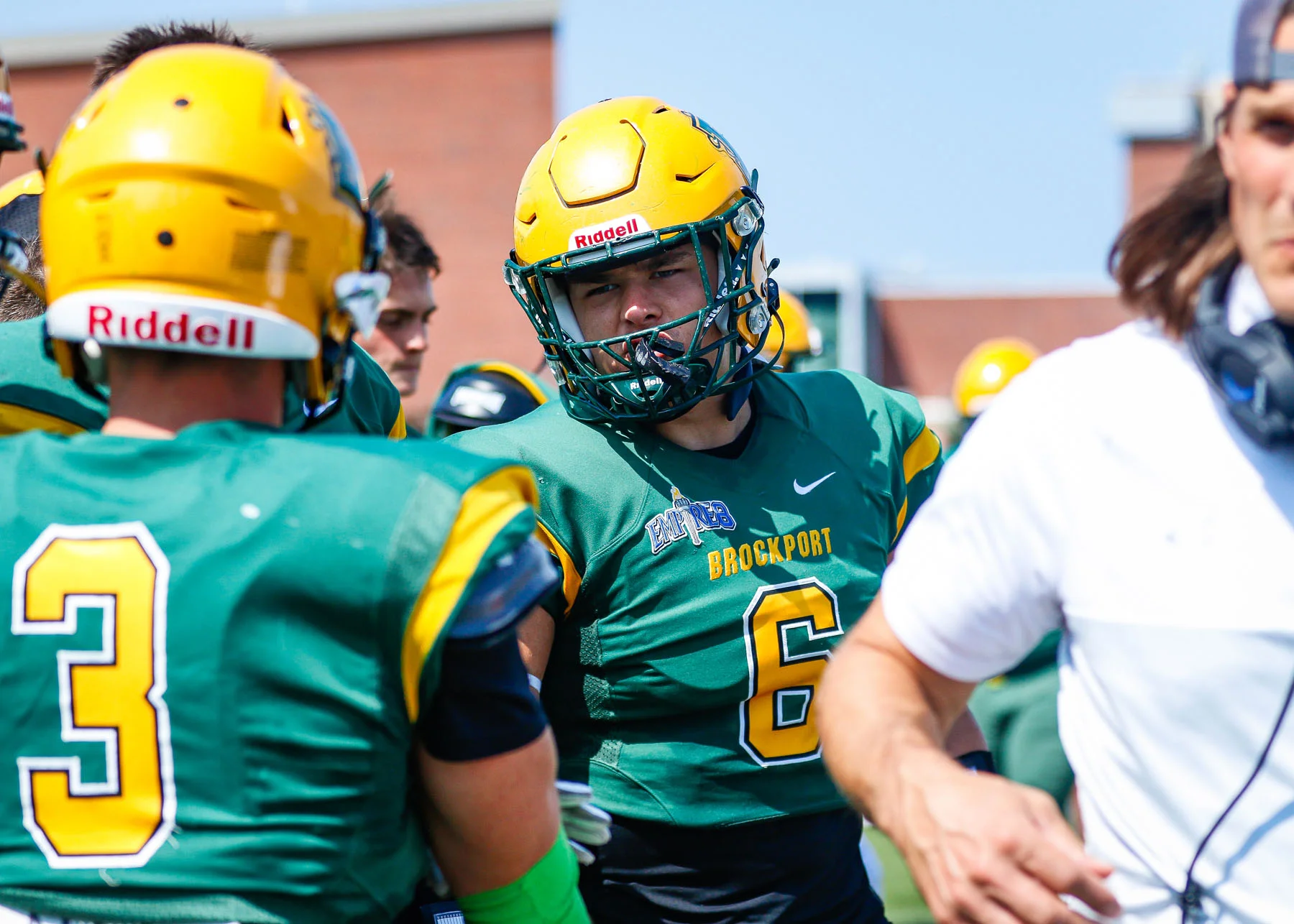 Brockport players talking on the sidelines