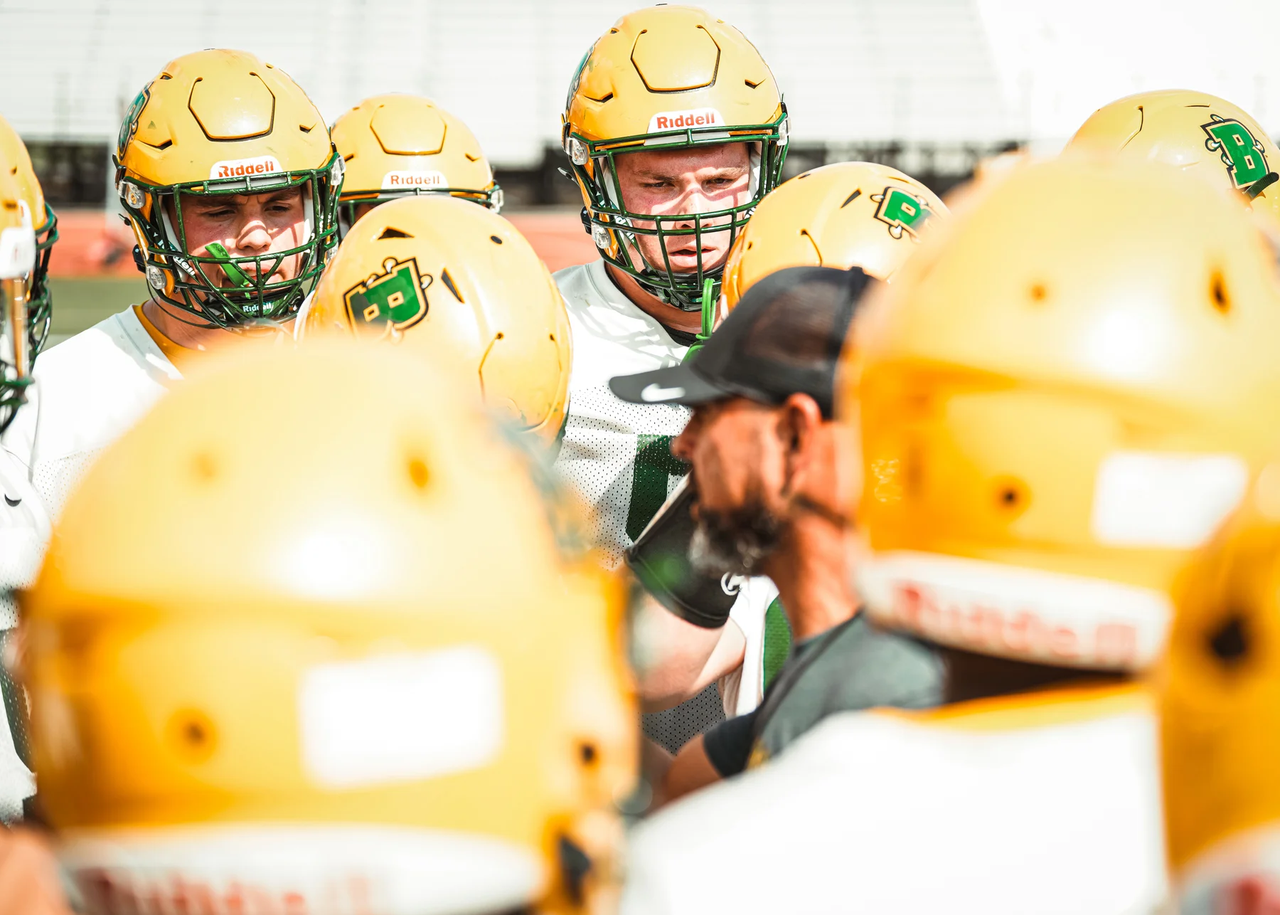 Brockport huddle with coach talking