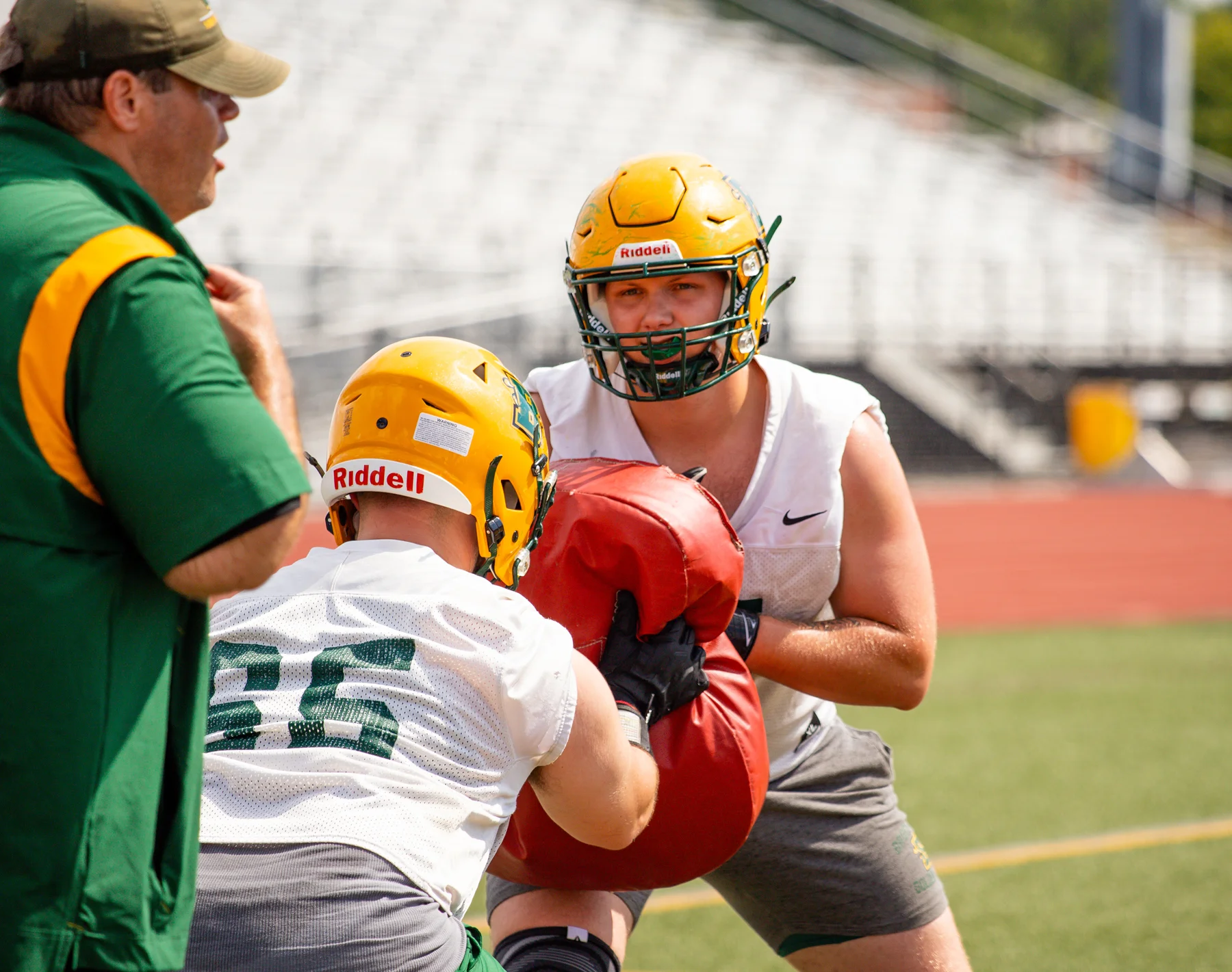 OL with the blocking drills while coach watches