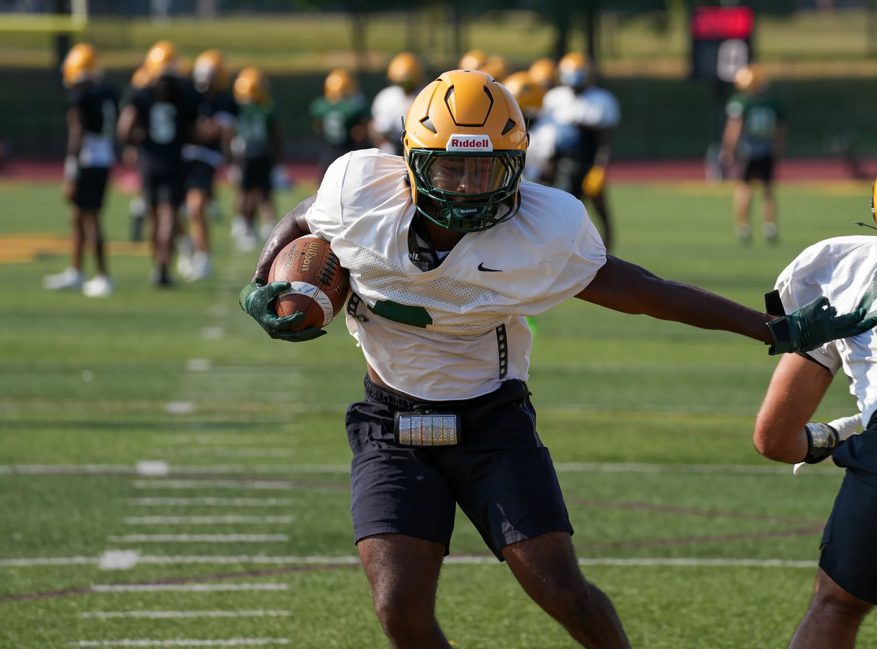 RB throwing out the stiff arm for Brockport