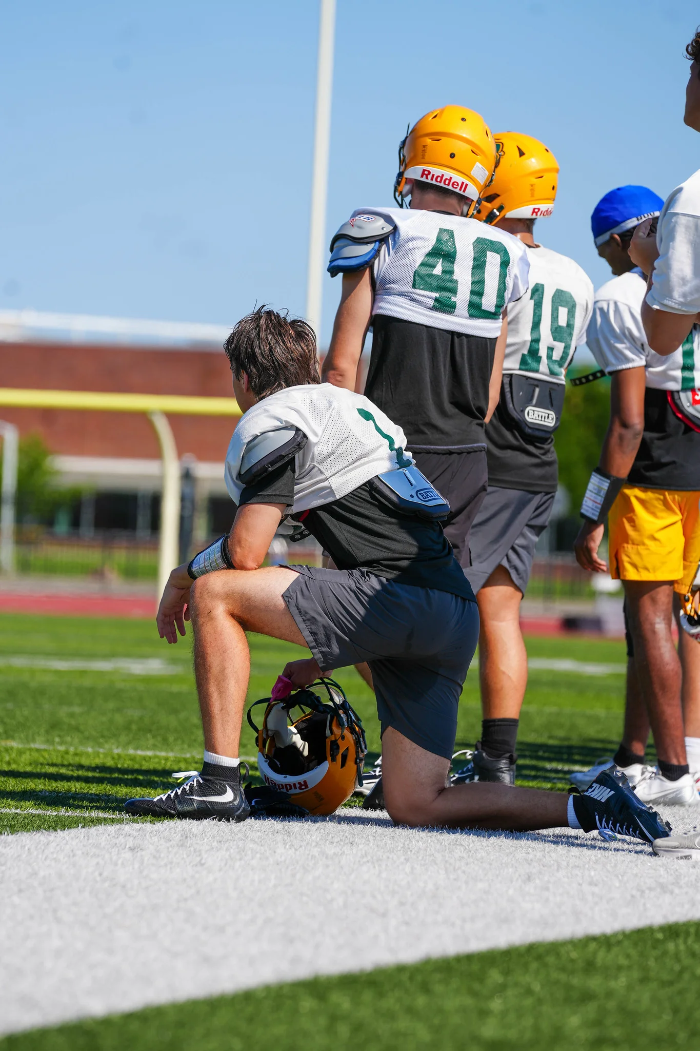 Players on the sidelines getting a breath at practice